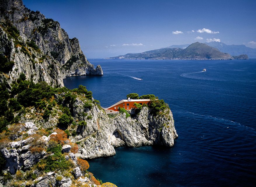 Capri: Island Boat Tour with Blue Grotto Stop - Passing through the Faraglioni Rocks