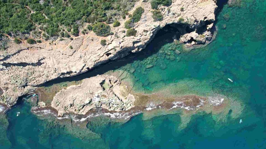 From Denia: Boat Trip to Tallada Cave with Optional Swim - Approaching Tallada Cave by catamaran