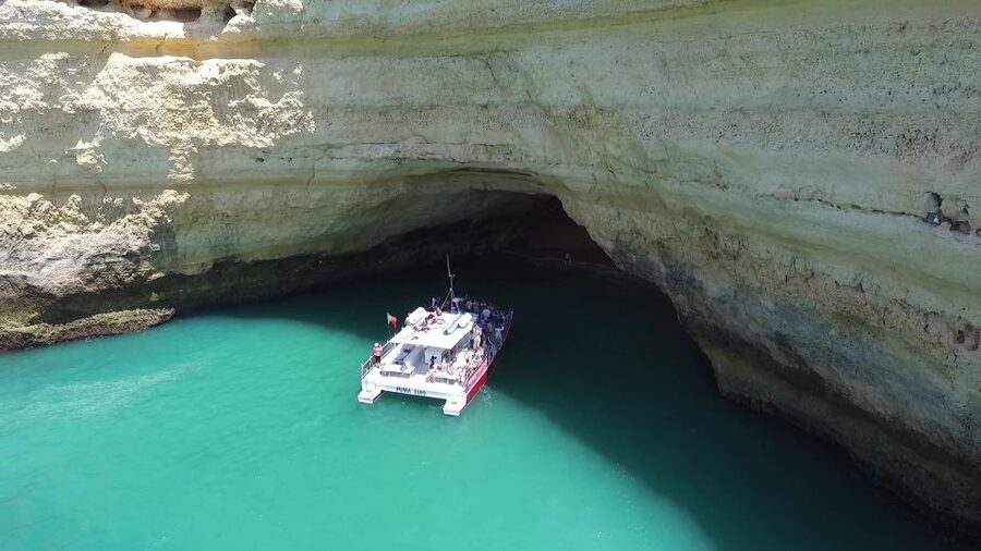 Quarteira: Benagil Cave Guided Catamaran Day Cruise & Drink - From Vilamoura Marina toward Benagil