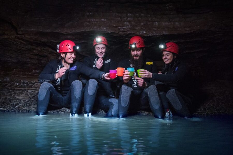 Waitomo Caves Black Abyss Ultimate Caving Experience - Crawling, climbing, and underground waterfalls